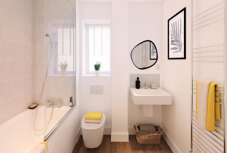 A bathroom with a bathtub, toilet, sink, and a towel rack.