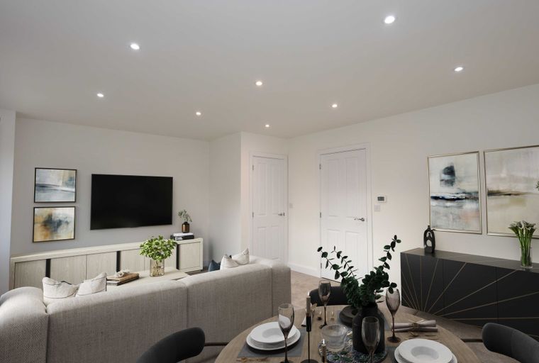 A living and dining room with a sofa, TV, dining table, and artwork.