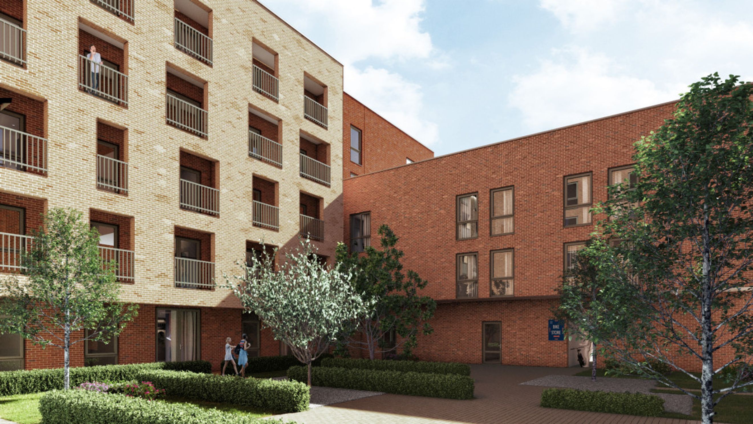 A courtyard view of a modern apartment building with light and red brick facades, balconies, trees, and landscaping.