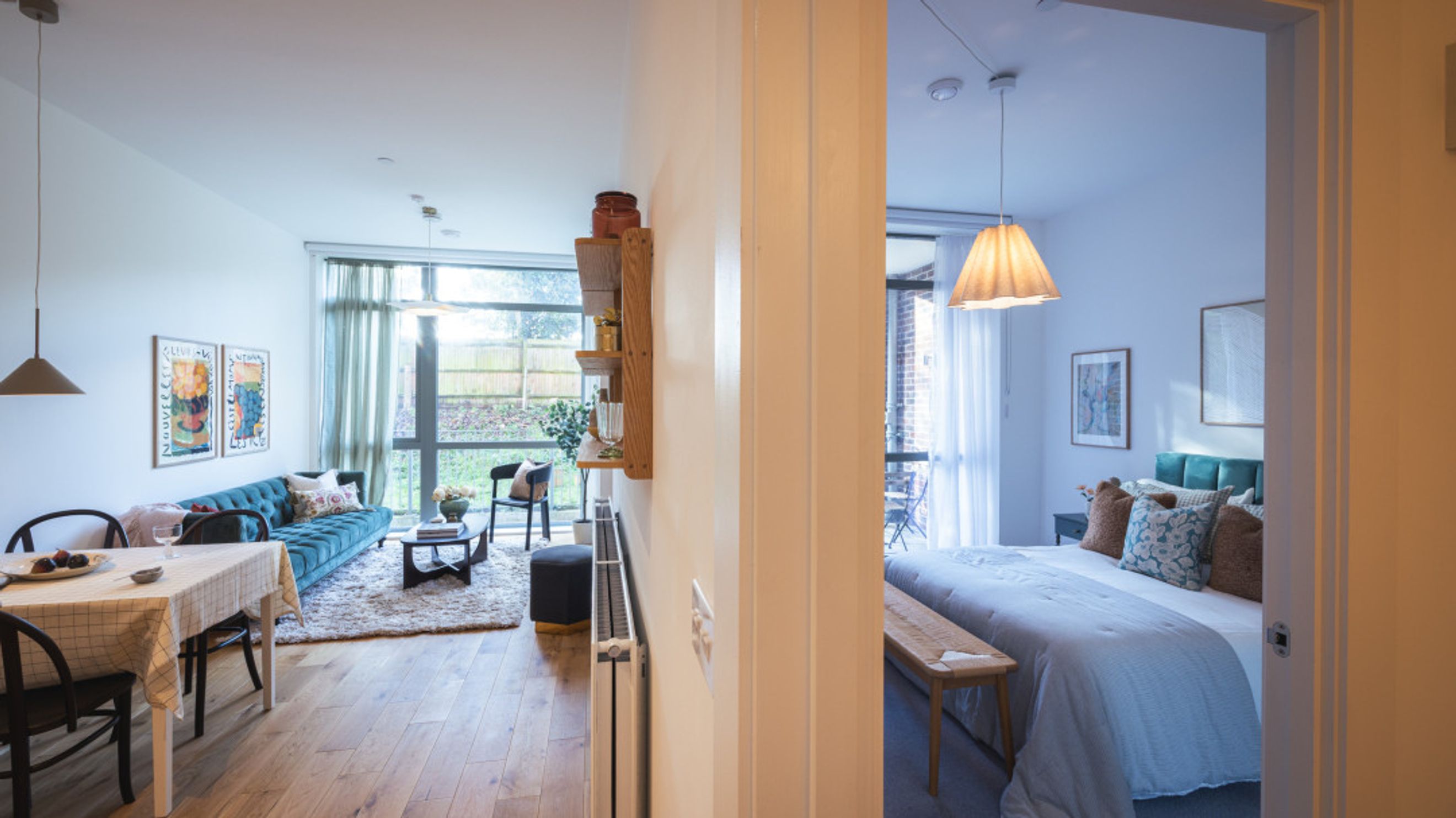 A living room and bedroom area viewed through an open doorway.