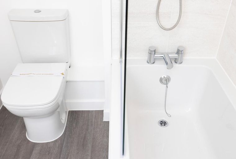 A toilet and a bathtub in a bathroom.