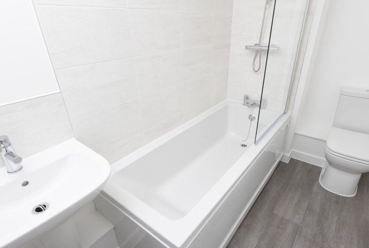 A bathroom with a bathtub, a sink, and a toilet.