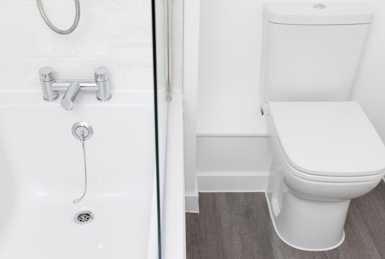 A bathroom with a bathtub and a toilet.