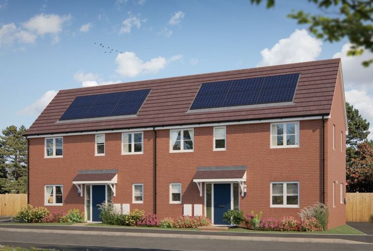 A row of red brick townhouses with solar panels on the roof, blue front doors, and gardens.