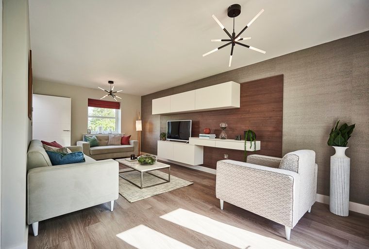 A living room with a sofa, armchair, coffee table, and entertainment unit.
