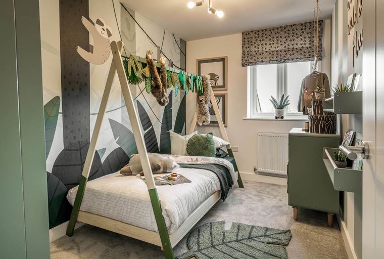 A child's bedroom with a teepee bed, sloth-themed wallpaper, and green furniture.