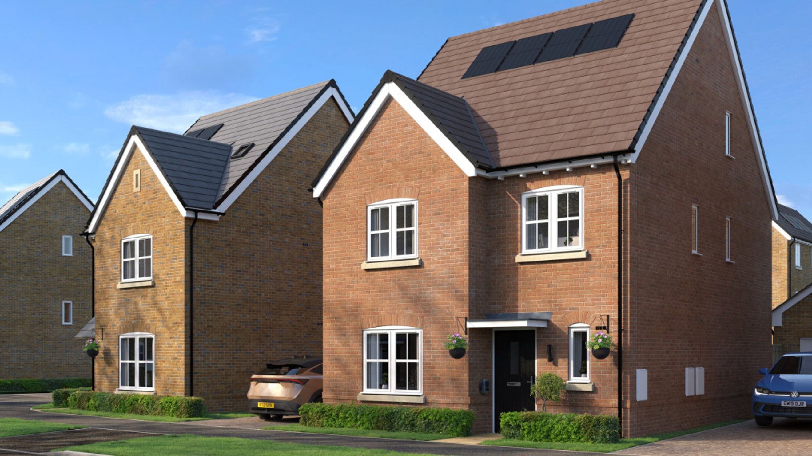 A row of modern brick houses with solar panels on the roof under a blue sky.