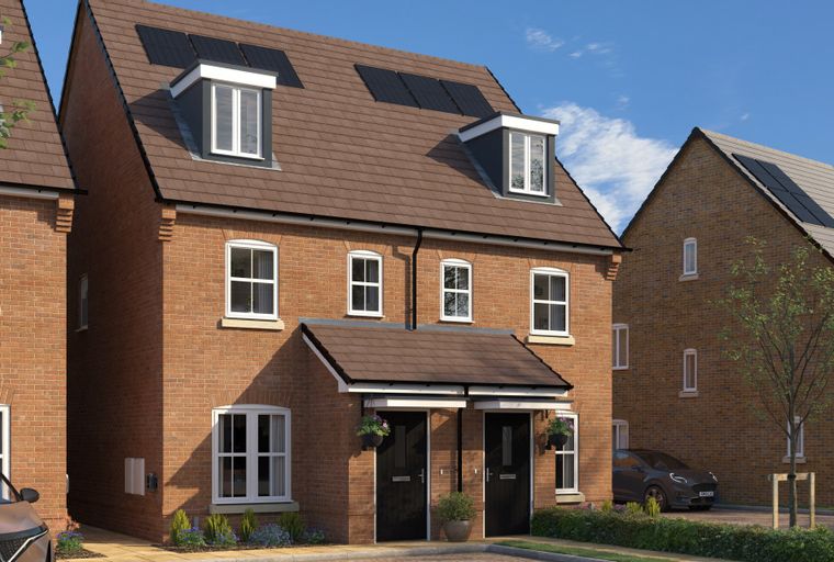 A row of modern brick houses with dormer windows and solar panels on the roof.
