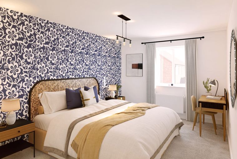 A bedroom with a bed, wallpaper, and a desk.