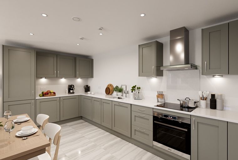 A modern kitchen with grey cabinets, a built-in oven, and a dining table.