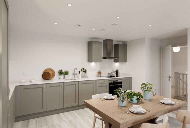 A kitchen and dining area with grey cabinets, a stainless steel range hood, and a wooden dining table.