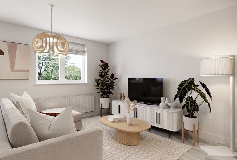 A living room with a sofa, coffee table, television, and plants.