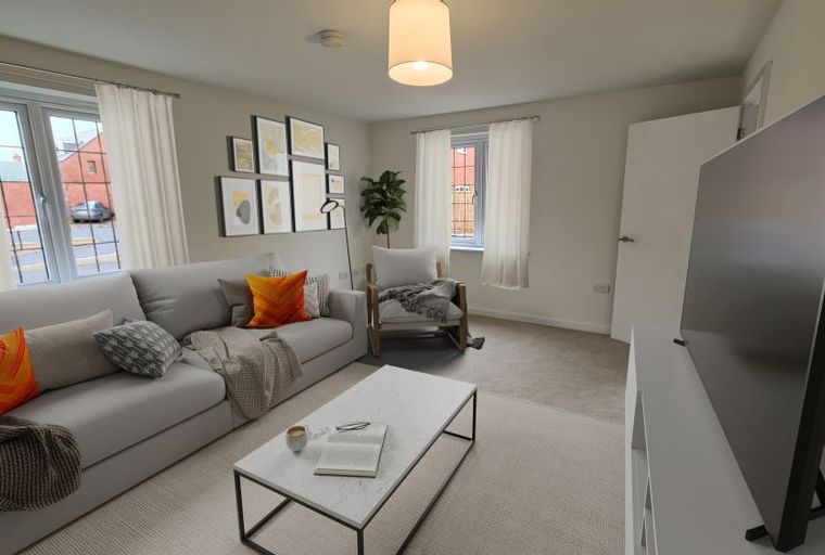 A living room with a sofa, coffee table, armchair, and a television.