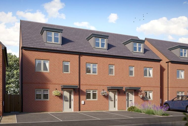 A row of red brick townhouses with dormer windows and front doors.