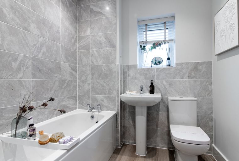 A bathroom with a bathtub, sink, and toilet.