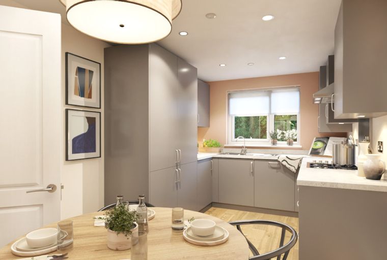 A modern kitchen and dining area with grey cabinets, a round table, and chairs.