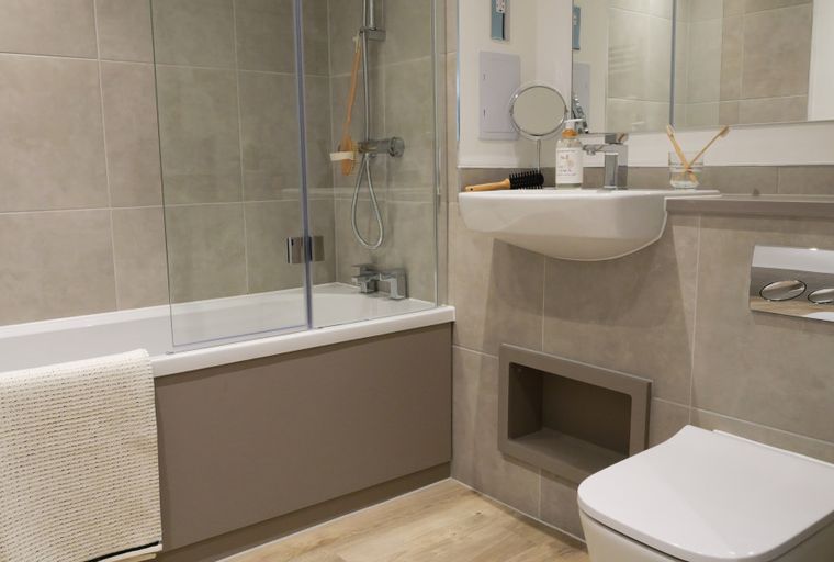A bathroom with a bathtub, sink, and toilet.