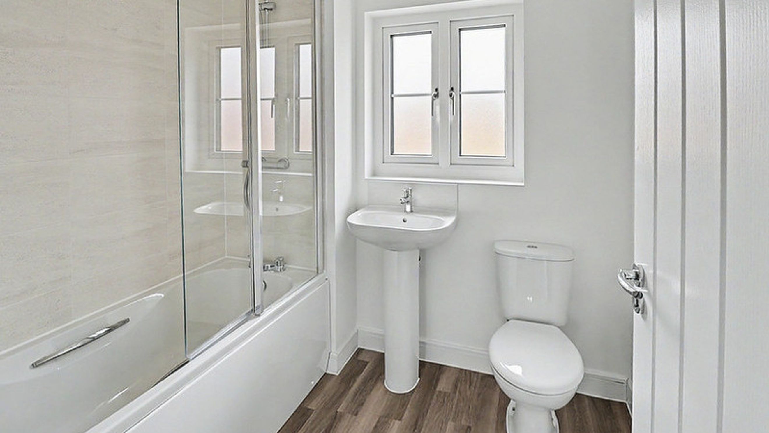 A bathroom with a bathtub, a sink, and a toilet.