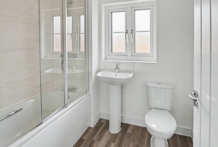 A bathroom with a bathtub, a sink, and a toilet.