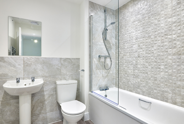 A bathroom with a bathtub, shower, sink, and toilet.