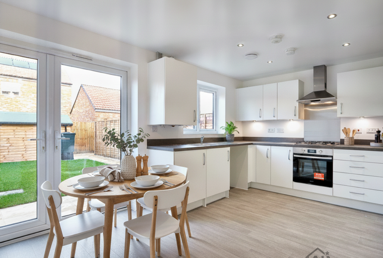 A kitchen and dining area with white cabinets, a wooden table, and chairs.