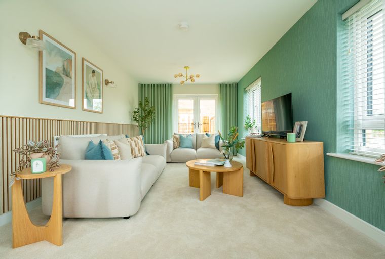 A living room with two sofas, a coffee table, and a media console.