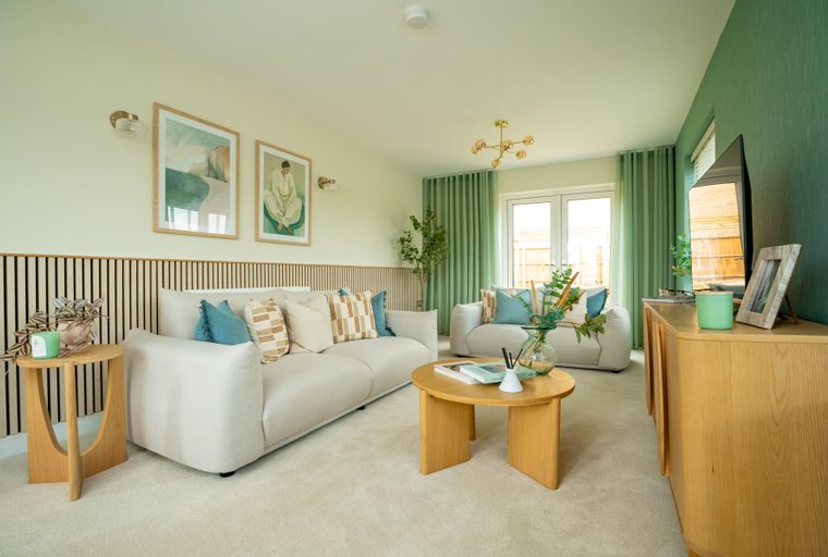 A living room with two sofas, a coffee table, and artwork on the wall.