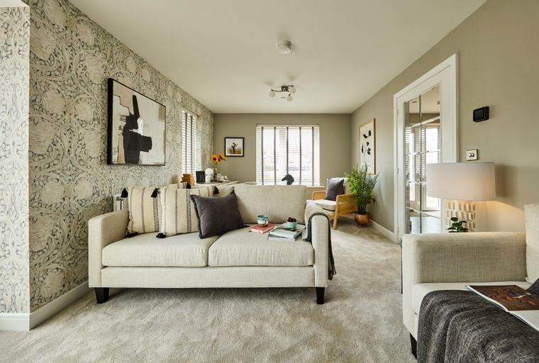 A living room with a sofa, pillows, and a coffee table.