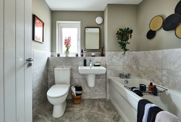 A bathroom with a toilet, sink, and bathtub.