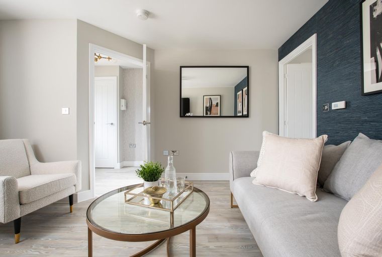A living room with a sofa, armchair, and coffee table.
