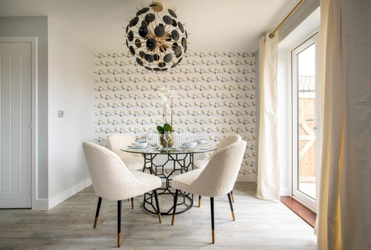 A dining table with four chairs and a chandelier.