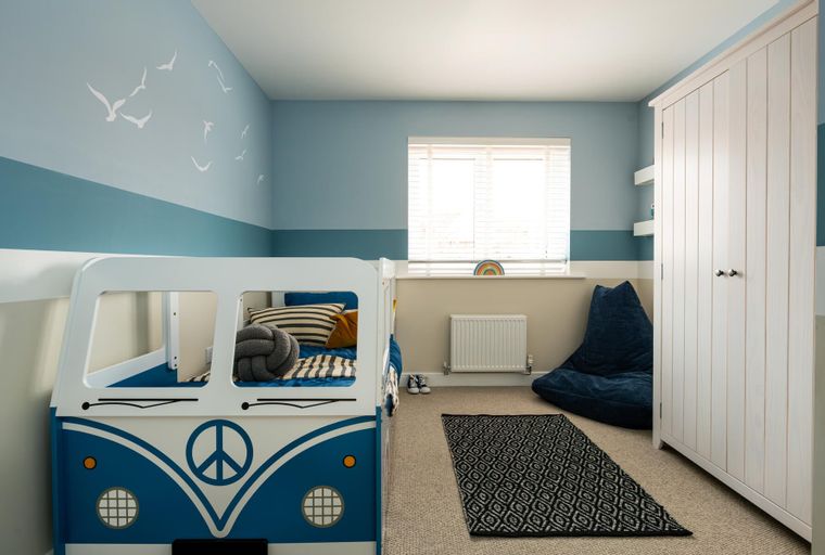 A child's bedroom with a camper van bed, a wardrobe, and a beanbag chair.