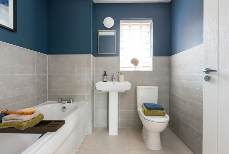 A bathroom with a bathtub, a sink, and a toilet.