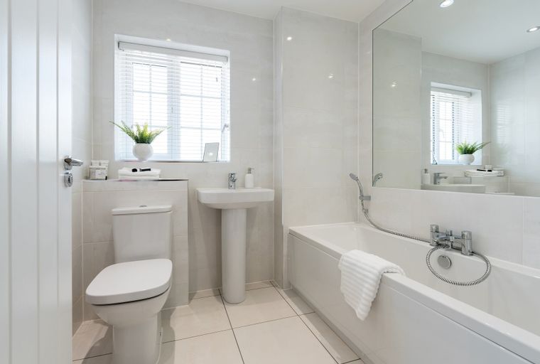 A bathroom with a toilet, sink, and bathtub.