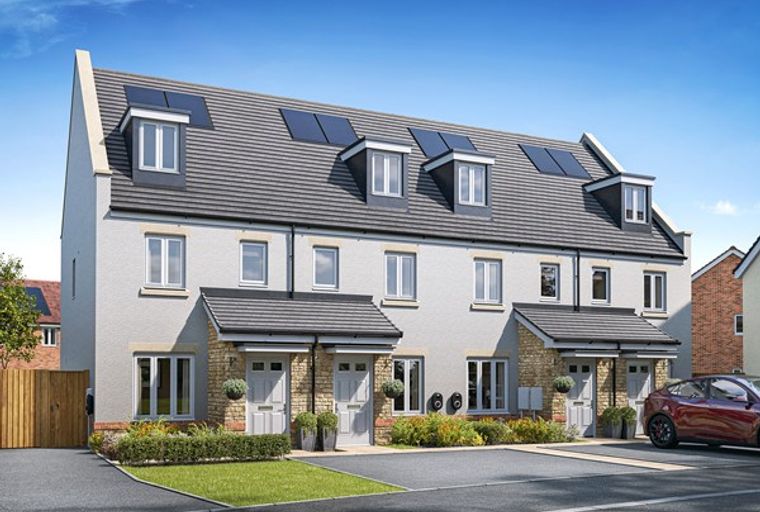 A row of modern townhouses with dormer windows and solar panels on the roof.