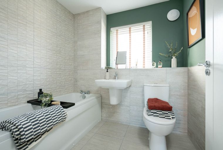 A bathroom with a bathtub, sink, and toilet.