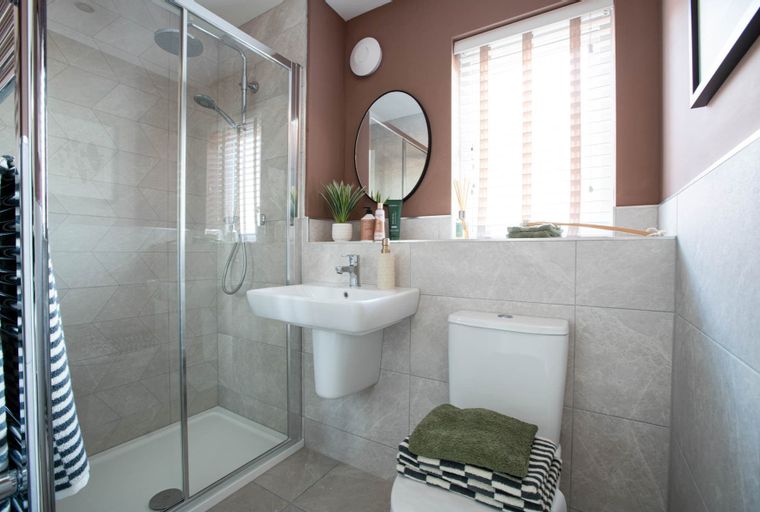 A bathroom with a shower, sink, and toilet.
