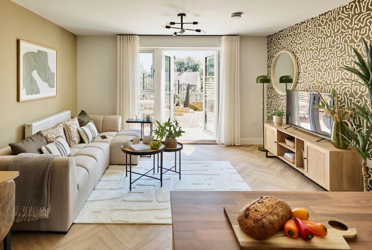 A living room with a sectional sofa, coffee table, and a television on a media console.