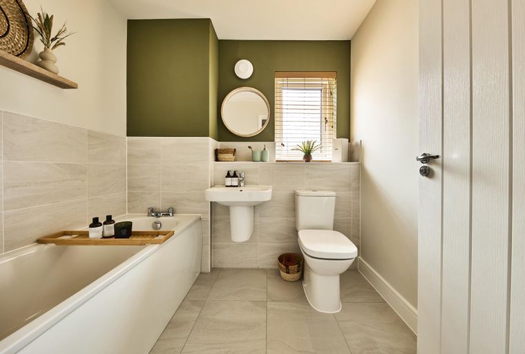 A bathroom with a bathtub, sink, and toilet.