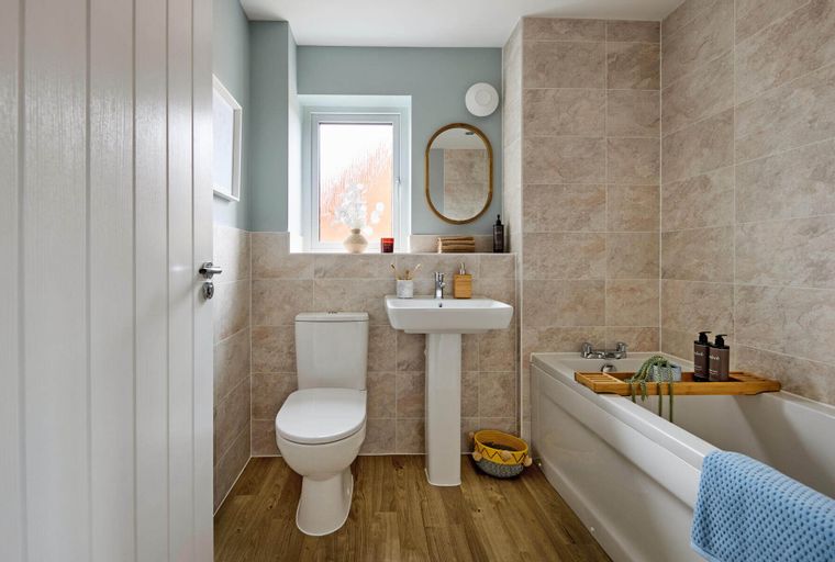 A bathroom with a toilet, sink, and bathtub.