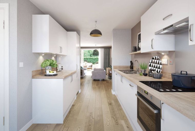 A modern kitchen with white cabinets, wooden countertops, and an oven.