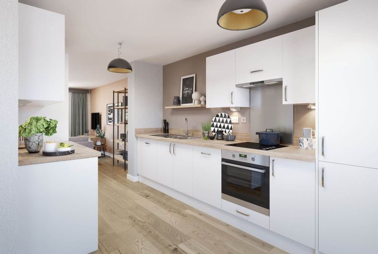 A modern kitchen with white cabinets, a light wood countertop, and integrated appliances.