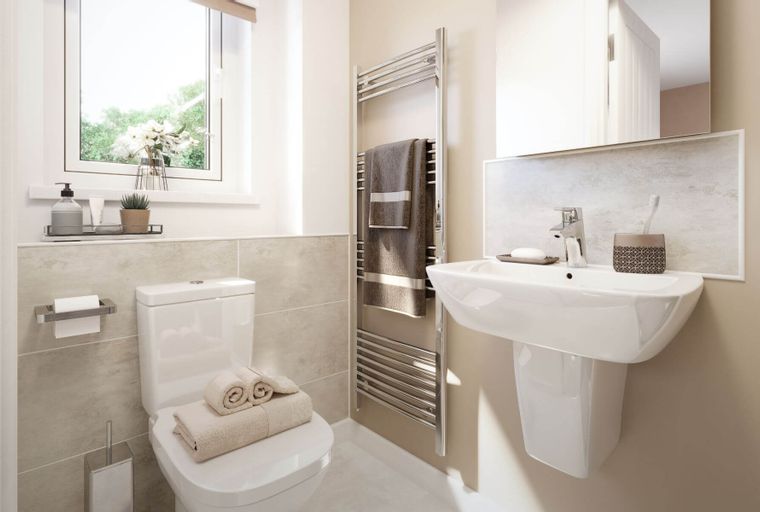 A bathroom with a toilet, sink, and heated towel rail.