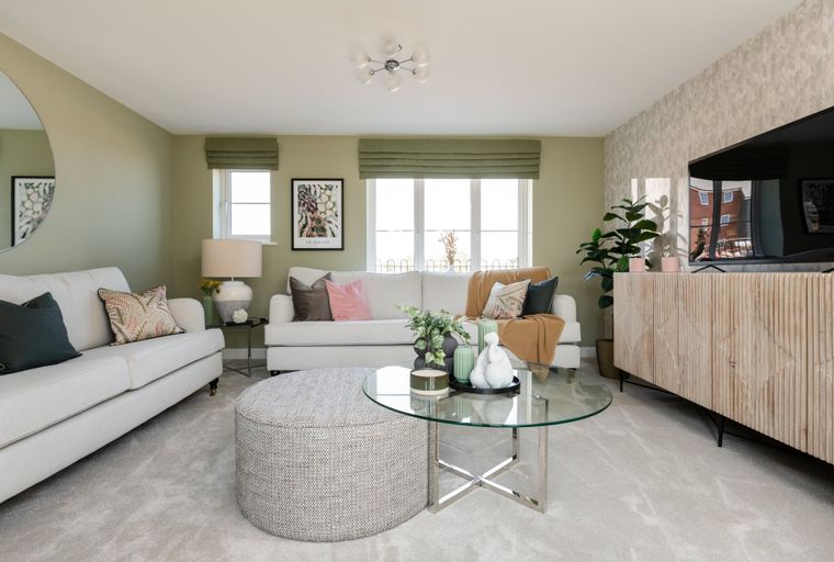 A living room with two sofas, a coffee table, and a television.
