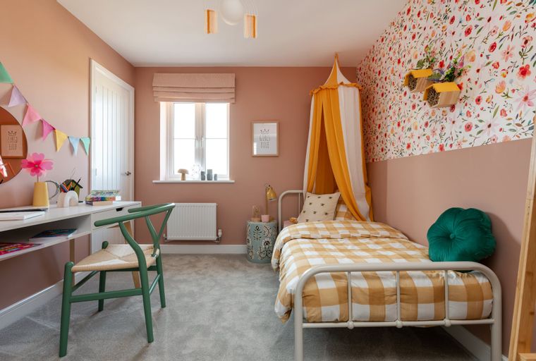 A child's bedroom with a bed, desk, and chair.
