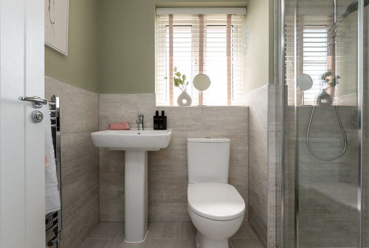 A bathroom with a sink, toilet, and shower.