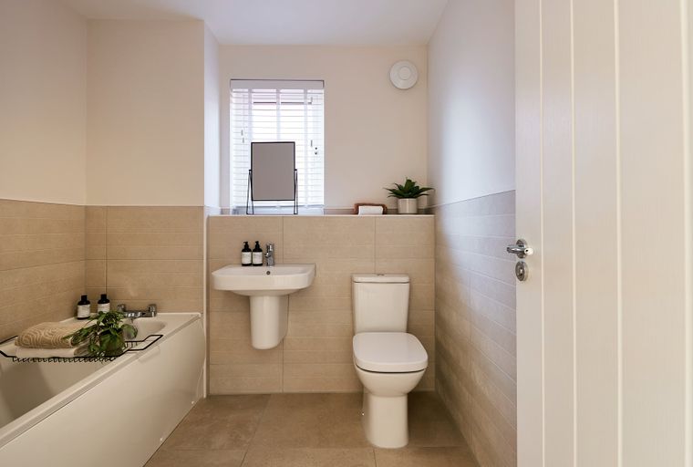 A bathroom with a bathtub, sink, and toilet.