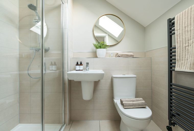 A bathroom with a shower, sink, and toilet.