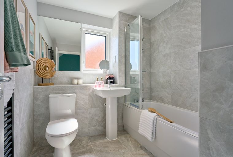 A bathroom with a toilet, sink, and bathtub.