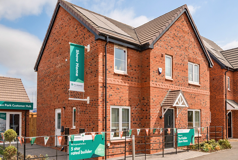 A brick house with a 'Show Home' banner and a sign that says 'The Kelder Show Home'.